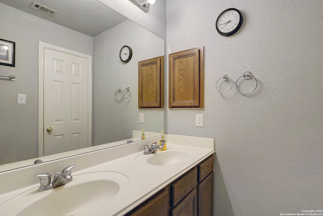 bathroom featuring vanity and a textured ceiling