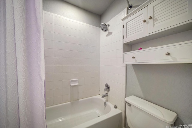 bathroom with shower / bath combination with curtain and toilet