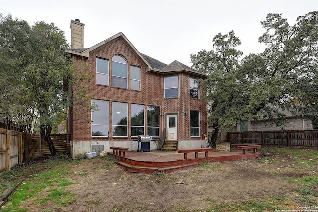 back of house with a wooden deck