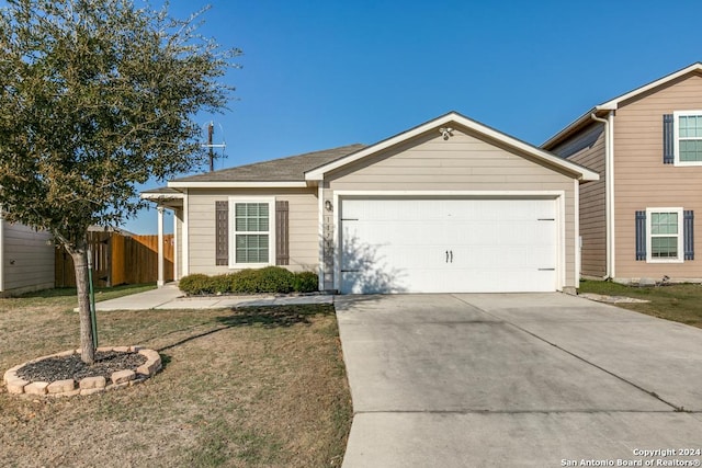 view of front of house featuring a front yard and a garage