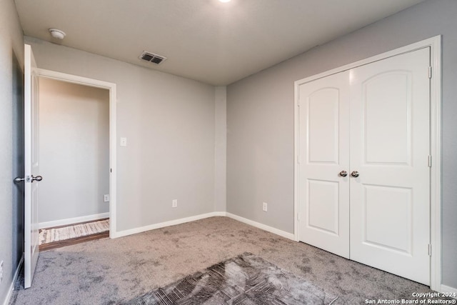 unfurnished bedroom with carpet and a closet