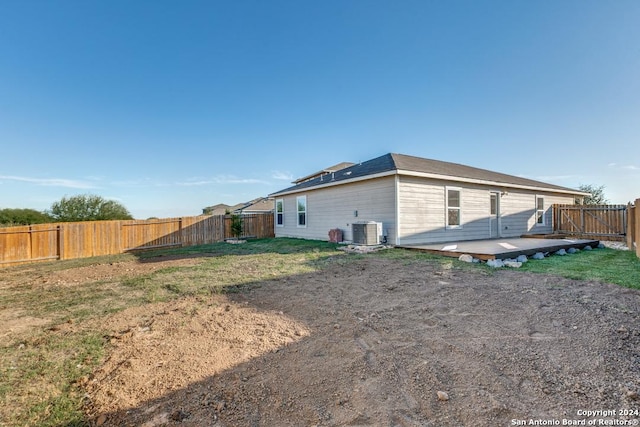 exterior space with a lawn and central air condition unit