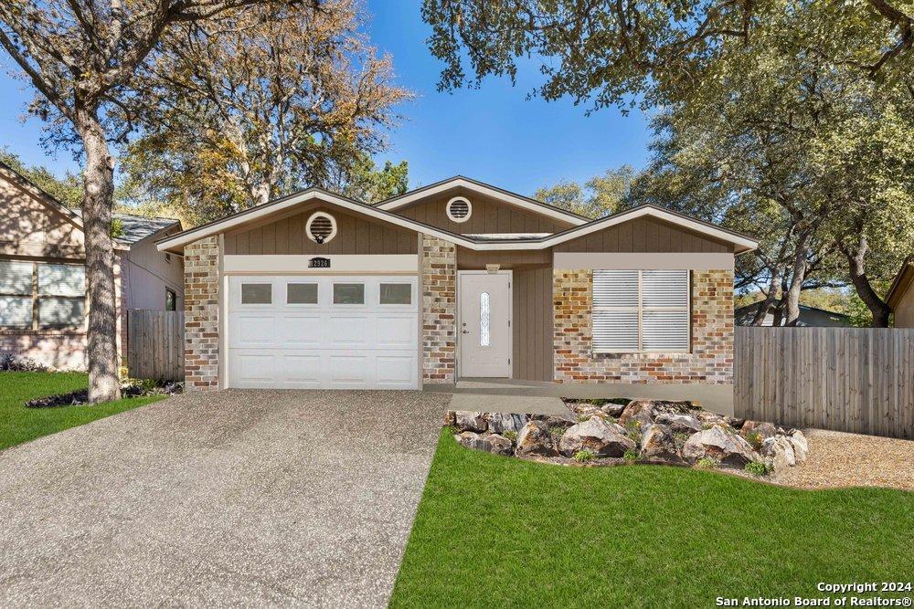 ranch-style home featuring a front yard and a garage