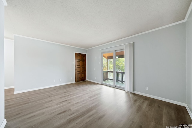 empty room with hardwood / wood-style floors, a textured ceiling, and crown molding