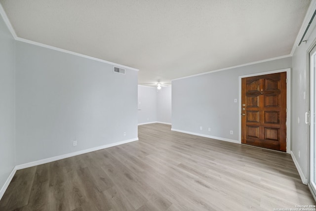 unfurnished room with light hardwood / wood-style floors and ornamental molding