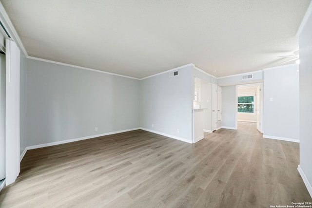 unfurnished living room with ceiling fan, light hardwood / wood-style floors, and ornamental molding