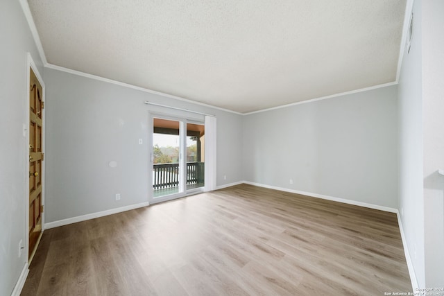 unfurnished room featuring light wood-type flooring, a textured ceiling, and ornamental molding