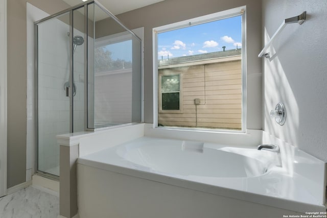 bathroom with separate shower and tub