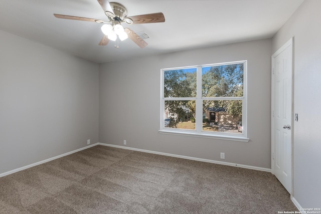 carpeted spare room featuring ceiling fan