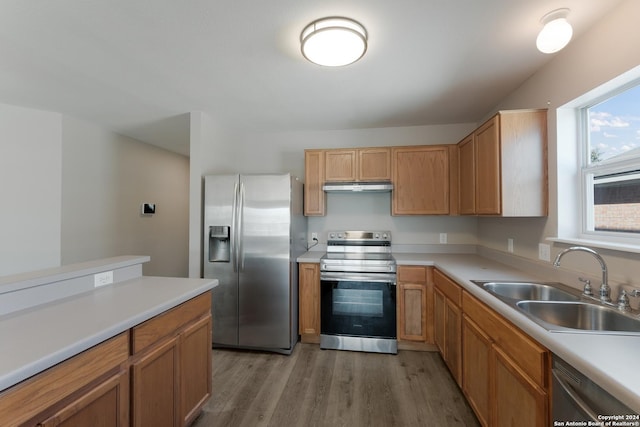 kitchen with sink, light hardwood / wood-style flooring, and appliances with stainless steel finishes