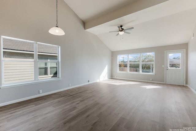 unfurnished living room featuring lofted ceiling with beams, ceiling fan, and wood-type flooring