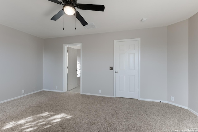 spare room featuring light carpet and ceiling fan