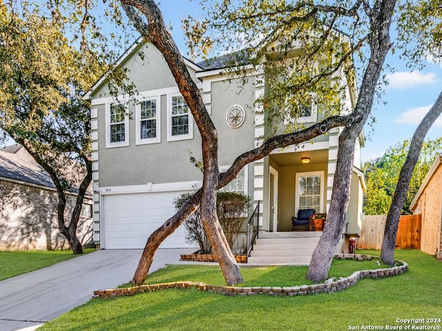 front of property with a front lawn and a garage