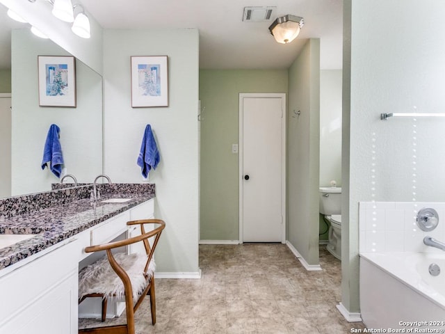 bathroom featuring vanity, toilet, and a bathing tub