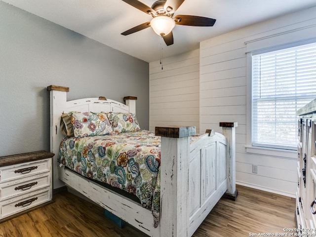 bedroom with dark hardwood / wood-style flooring, multiple windows, and ceiling fan