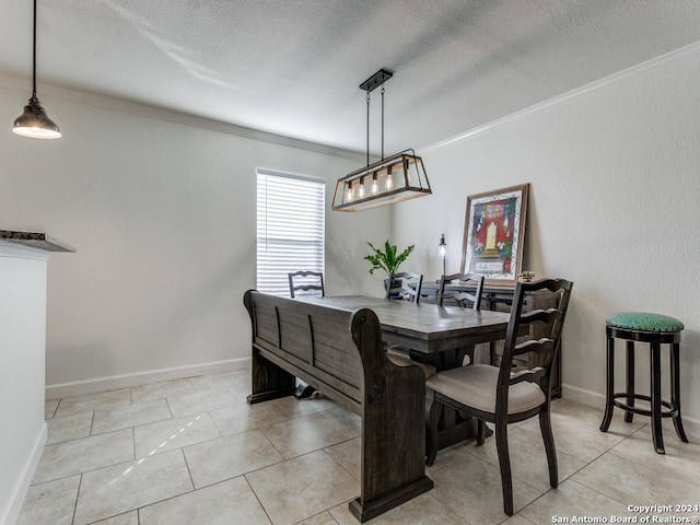 dining area with crown molding, light tile patterned floors, and a textured ceiling