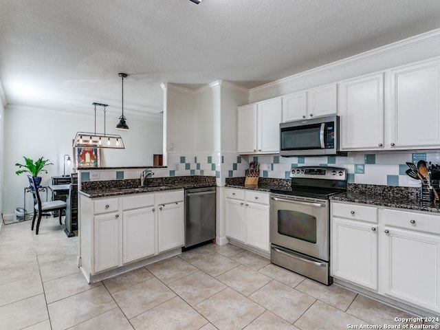 kitchen featuring sink, hanging light fixtures, crown molding, white cabinets, and appliances with stainless steel finishes