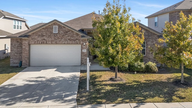 view of front of property featuring a front lawn and a garage