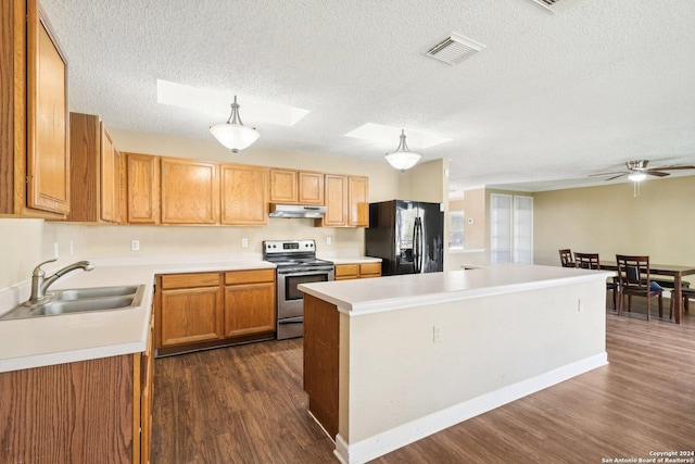 kitchen with dark hardwood / wood-style floors, black fridge, electric stove, and hanging light fixtures