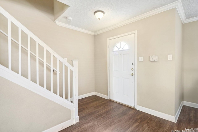 entrance foyer with crown molding, dark wood-type flooring, and a textured ceiling