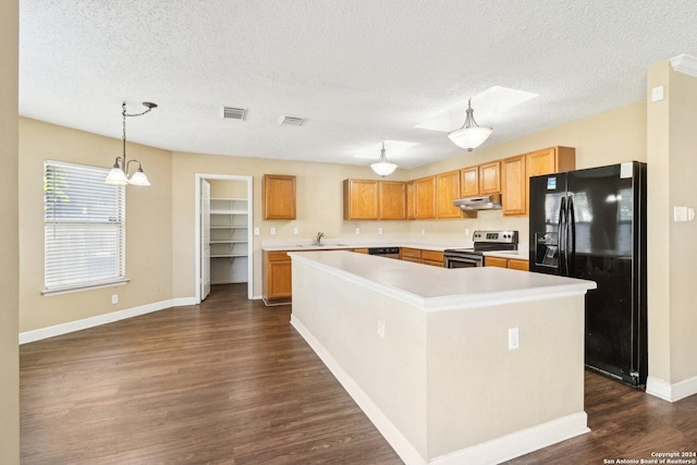 kitchen featuring a center island, hanging light fixtures, black fridge, dark hardwood / wood-style flooring, and stainless steel electric stove