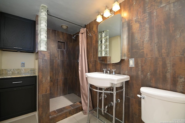 bathroom featuring a shower with curtain, tile patterned flooring, tile walls, and toilet