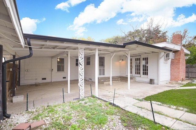 back of house featuring a patio area and a wall mounted air conditioner