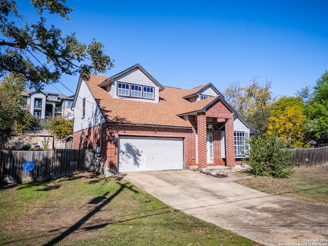 view of front of house with a front yard and a garage