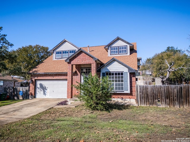 view of front of home with a front yard and a garage