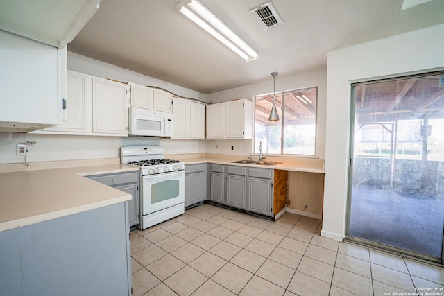 kitchen featuring gray cabinetry, white appliances, white cabinets, sink, and light tile patterned flooring