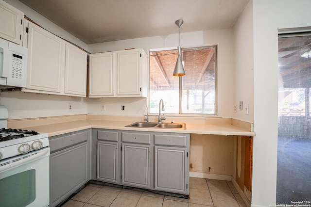 kitchen with gray cabinetry, white appliances, sink, hanging light fixtures, and light tile patterned flooring