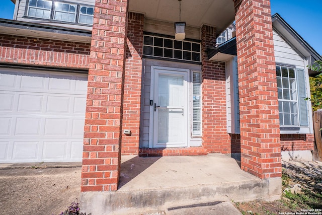 view of exterior entry with a garage