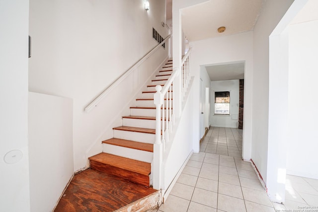 stairway featuring tile patterned floors