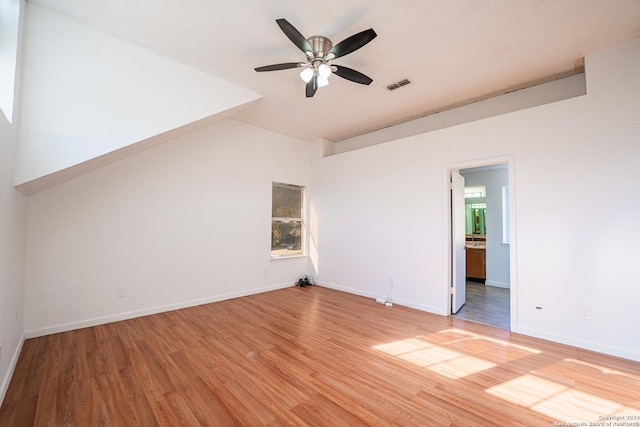 unfurnished room featuring ceiling fan, lofted ceiling, and hardwood / wood-style flooring