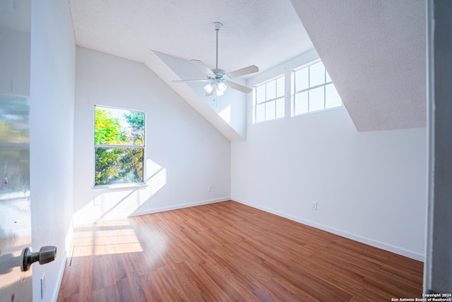 bonus room with hardwood / wood-style floors, ceiling fan, lofted ceiling, and a textured ceiling