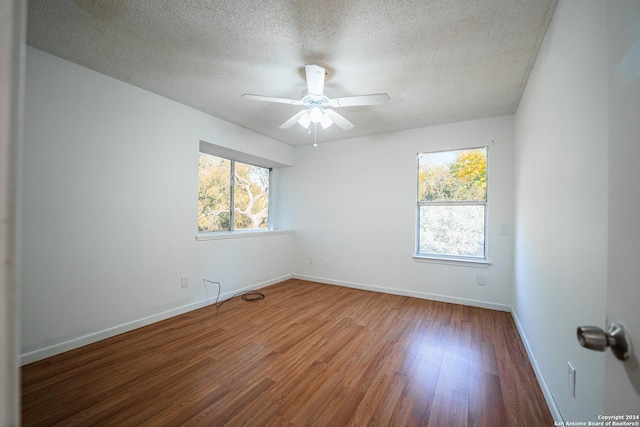 spare room featuring ceiling fan, a textured ceiling, and hardwood / wood-style flooring