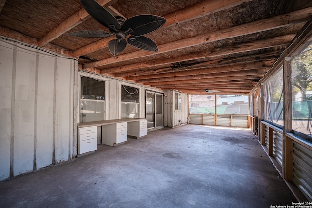 unfurnished sunroom with ceiling fan