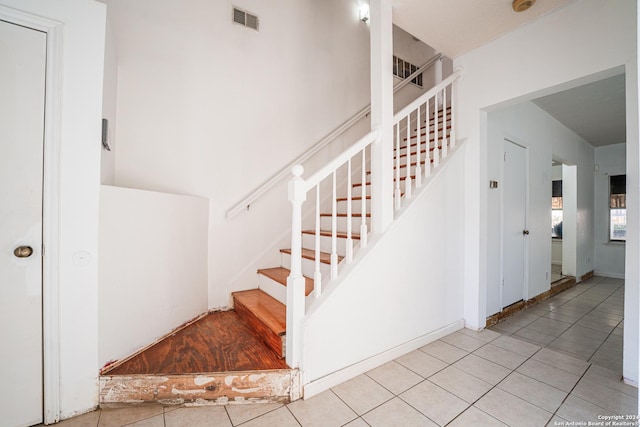 stairs with tile patterned floors