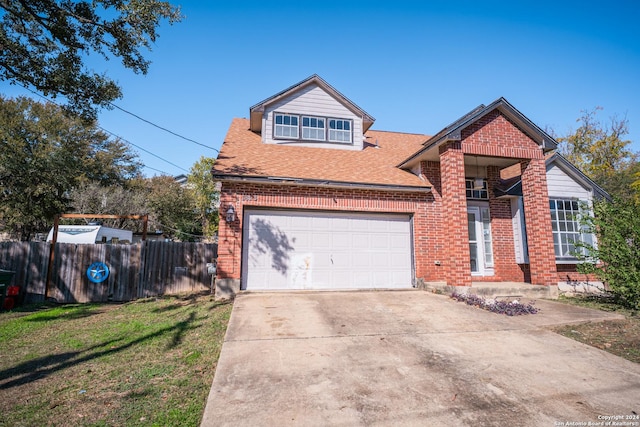 view of property with a front yard and a garage