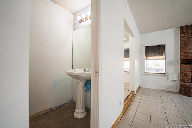 bathroom featuring tile patterned flooring and a textured ceiling