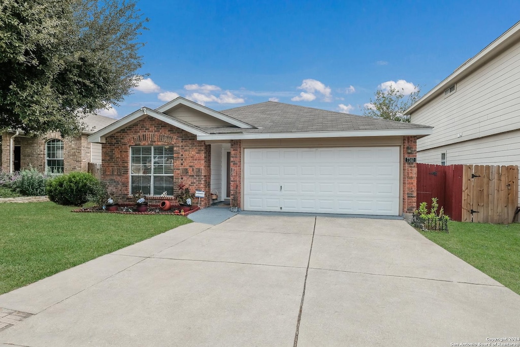 view of front of house featuring a garage and a front lawn