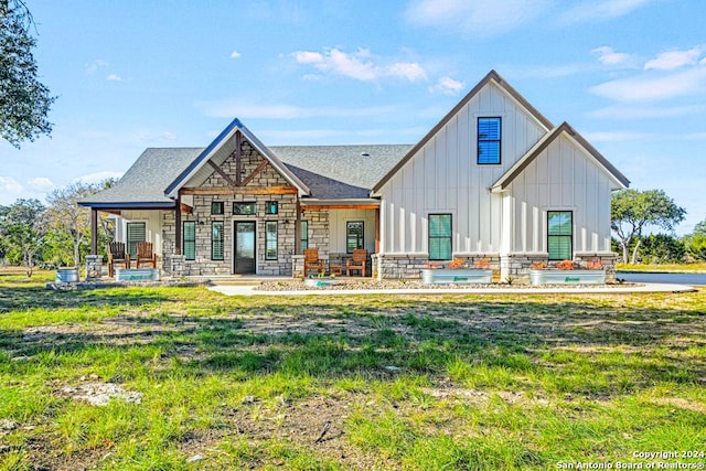 rear view of property with covered porch