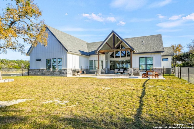 rear view of house with a lawn, outdoor lounge area, and a patio