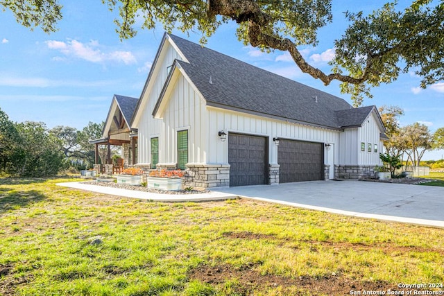 view of side of home with a lawn and a garage