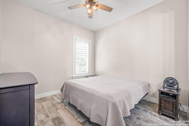 bedroom with wood-type flooring and ceiling fan