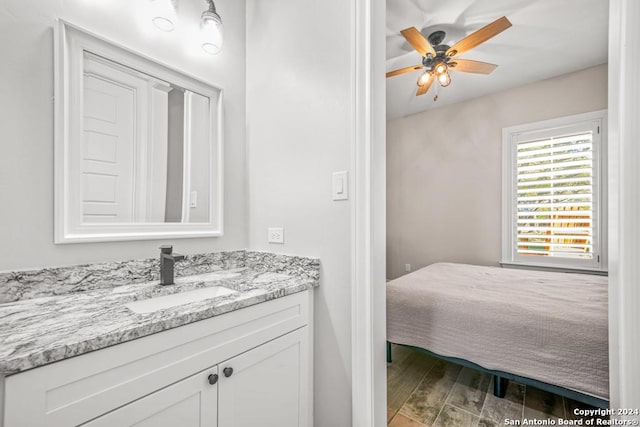 bathroom with ceiling fan, vanity, and wood-type flooring