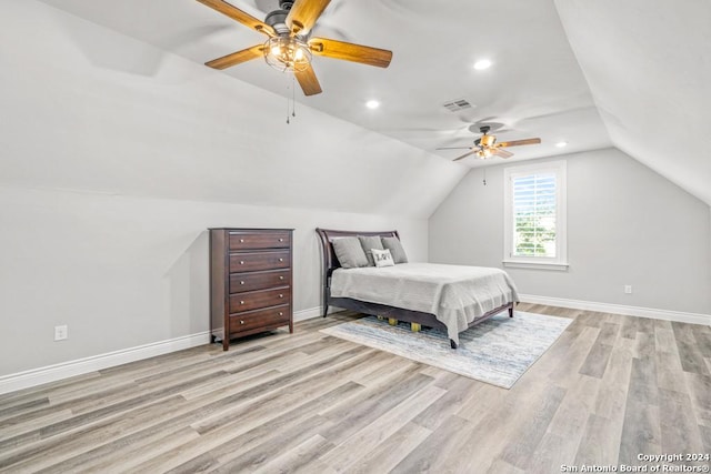 bedroom featuring ceiling fan, light hardwood / wood-style floors, and lofted ceiling