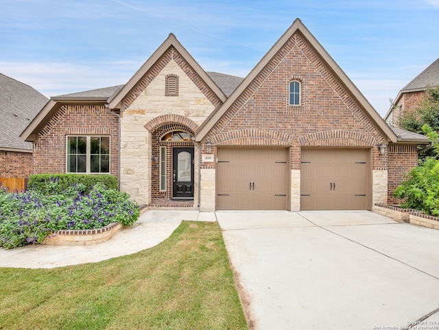 view of front facade featuring a garage and a front lawn