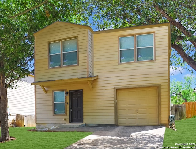 view of front of home featuring a front yard and a garage