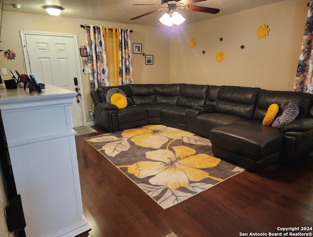 living room featuring ceiling fan, wood-type flooring, and a textured ceiling